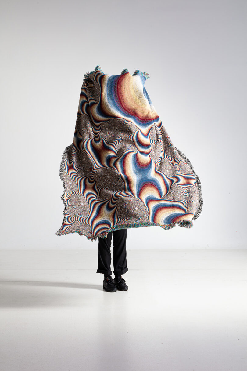 multi-colored patterned textile being held up by a person