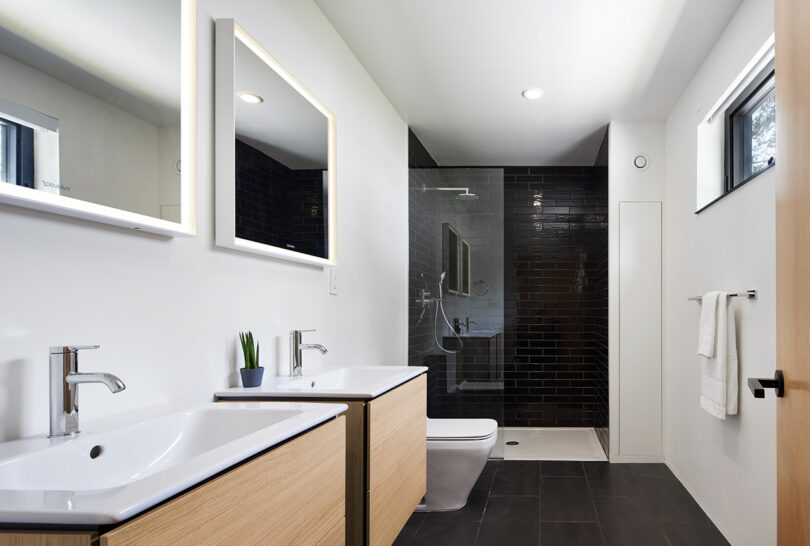 Bathroom with black accent tile in standing shower.