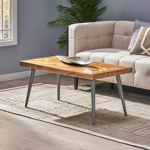 A boho living room with wooden coffee table.