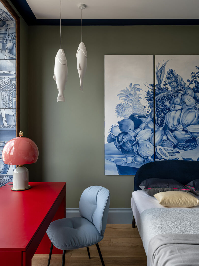 partial view of modern bedroom with large blue and white artwork above bed with light colored linens and red desk to the side