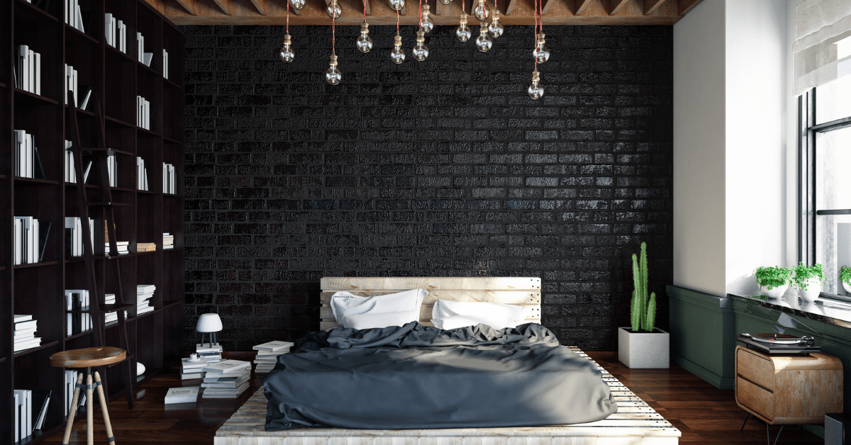 A black bedroom with a large bookcase and unique ceiling lights.