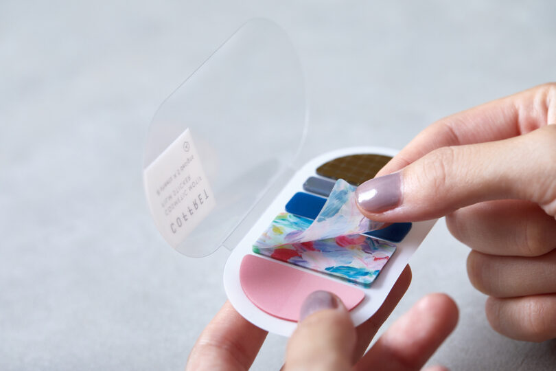 hand peeling off a sticker from a palette