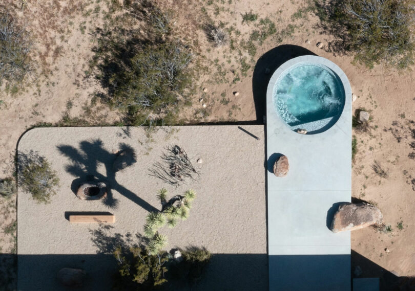 down view looking at modern concrete outdoor patio with circular pool