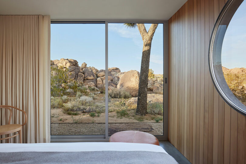 partial view of modern bedroom looking out sliding glass doors to desert