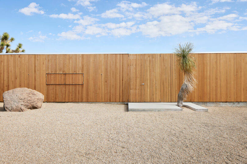 exterior view of modern wood pavilion style house in desert