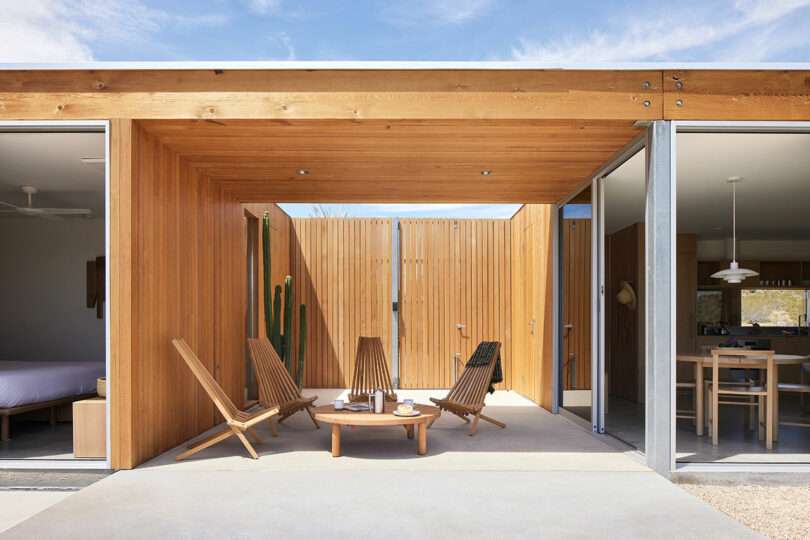 exterior shot of modern home with central covered patio with modern chairs in circle