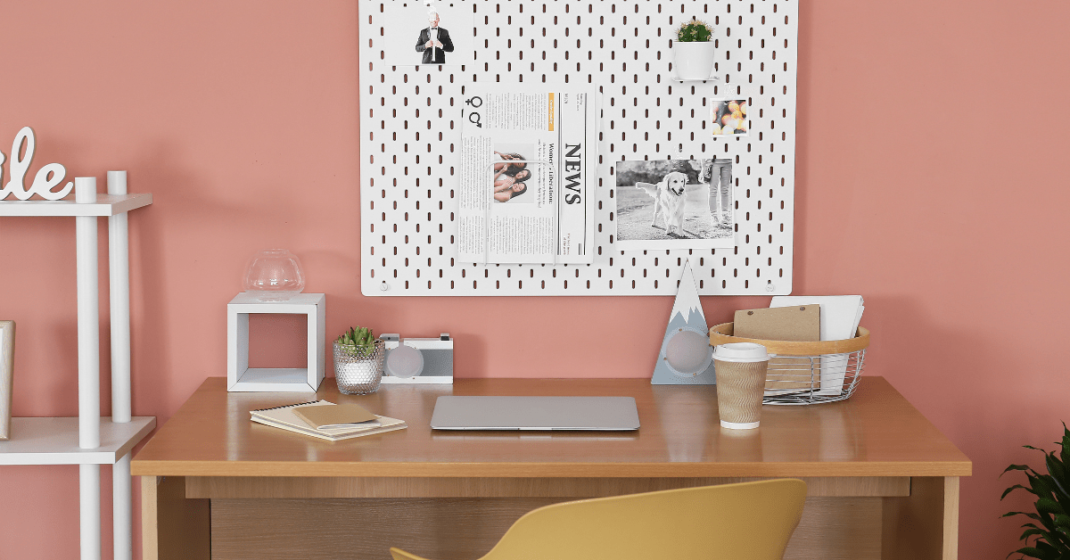 A colorful office with pegboard that showcases unique art as decor.