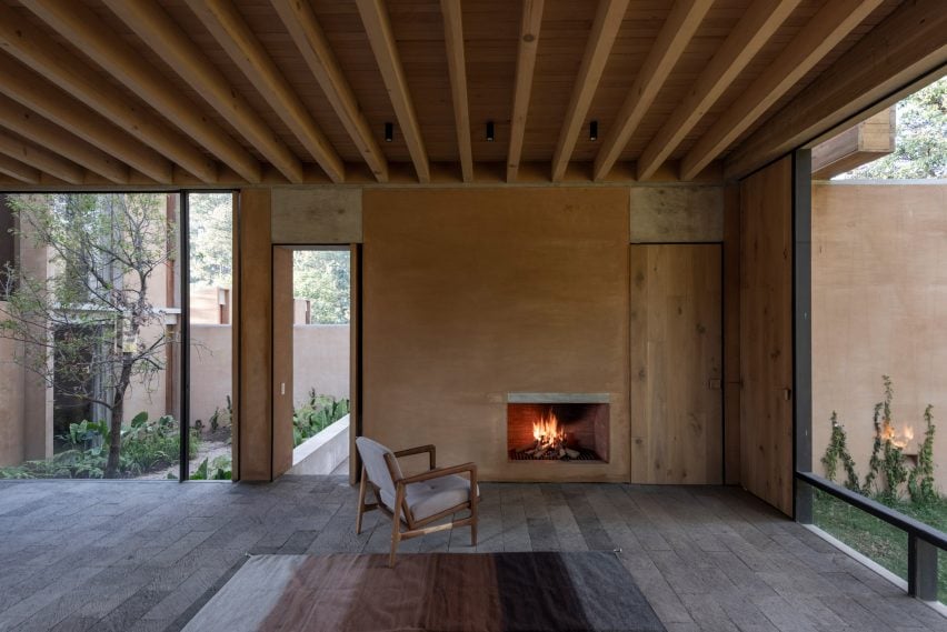 An armchair placed next to fireplace