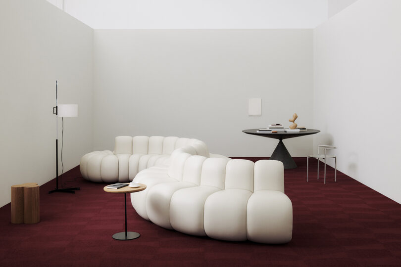 tone on ton red rug with modern white sofas and round tables