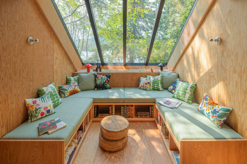 view into U-shaped nook with built-in seating under sloped windows