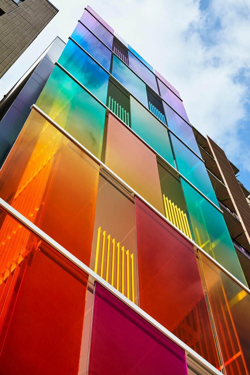 upward angled exterior view of rainbow fronted office building