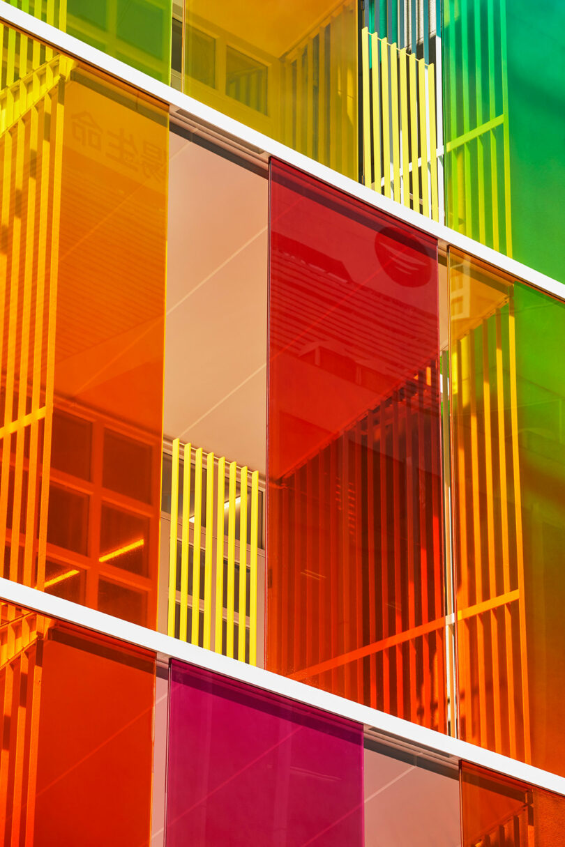 closeup angled exterior view of rainbow fronted office building