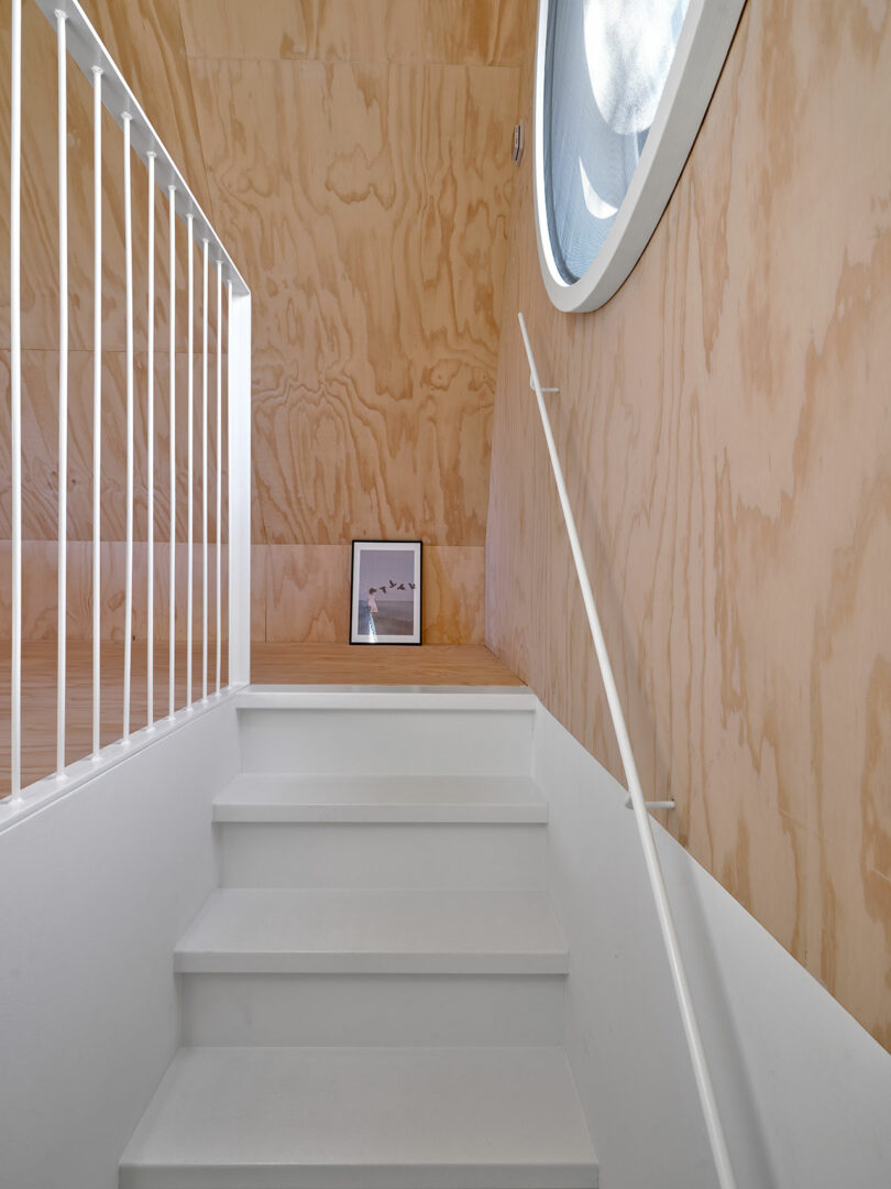 A white staircase in a modern cabin.