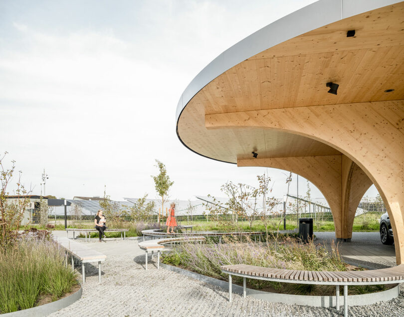 A circular wooden charging park with benches.
