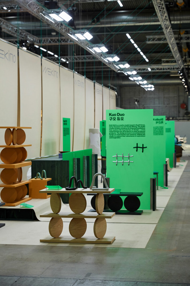 Exhibition hall with modern furniture display and informational placards.