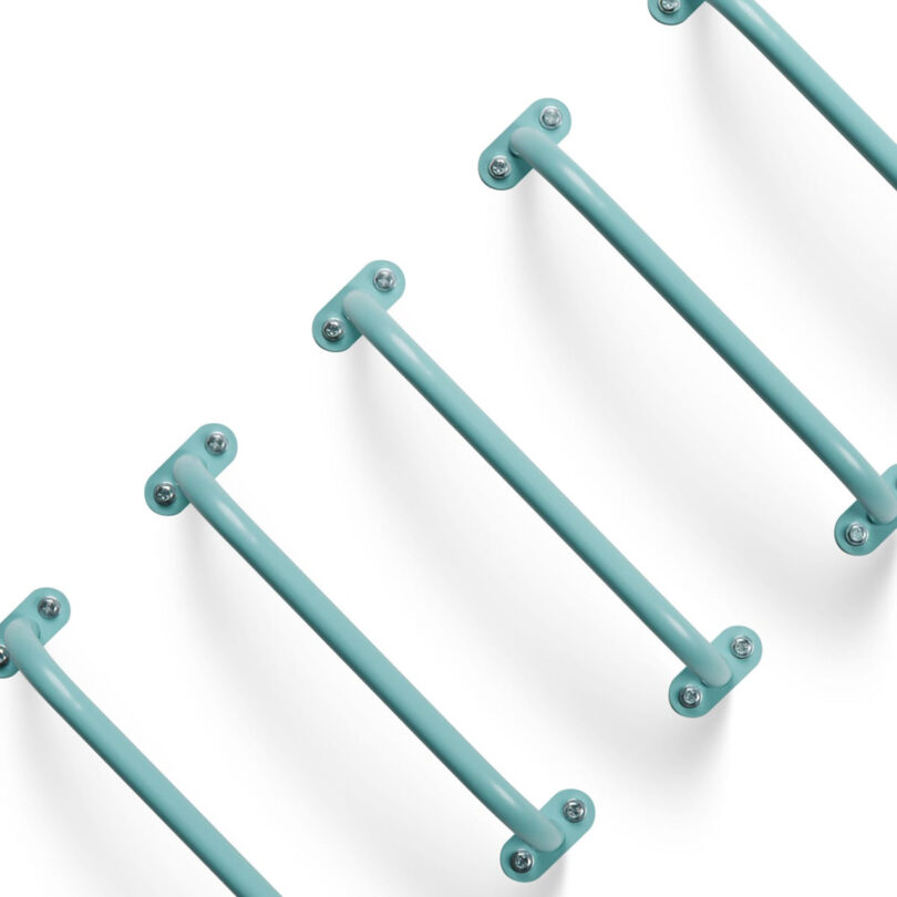 Five teal powder coated Randle Wall Climbing Handles in diagonal vertical ladder configuration.