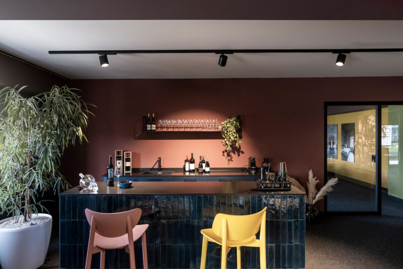 Modern bar interior with dark tones and contrasting NOA colored chairs.