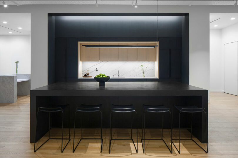 A kitchenette with bar counter and stools.