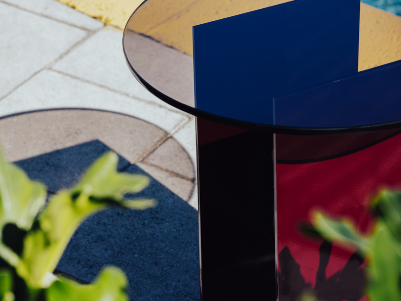 details of red metal and bronze glass table