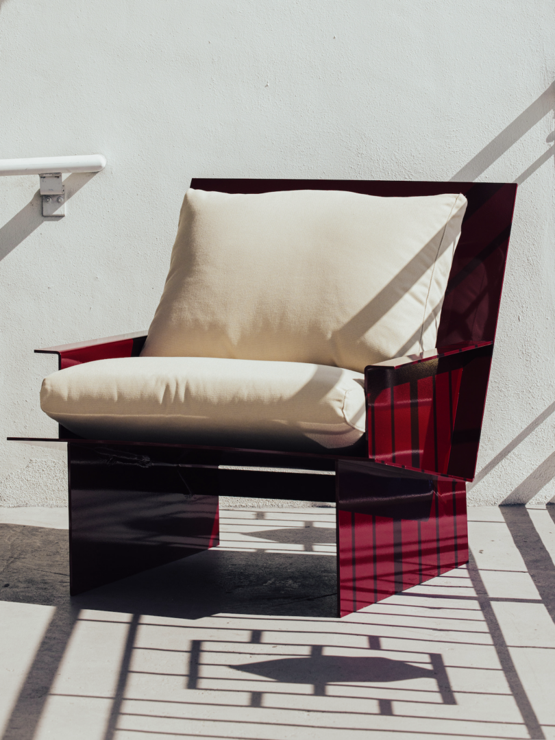 red metal chair with white upholstery outdoors