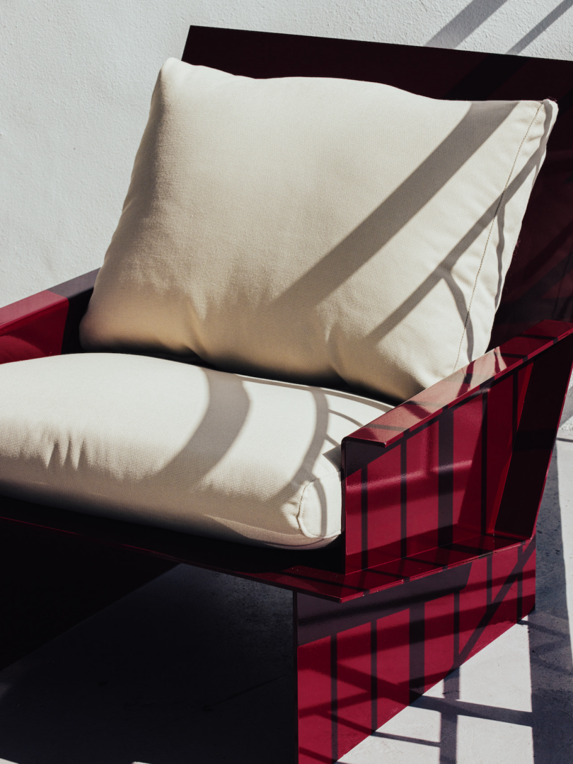 red metal chair with white upholstery