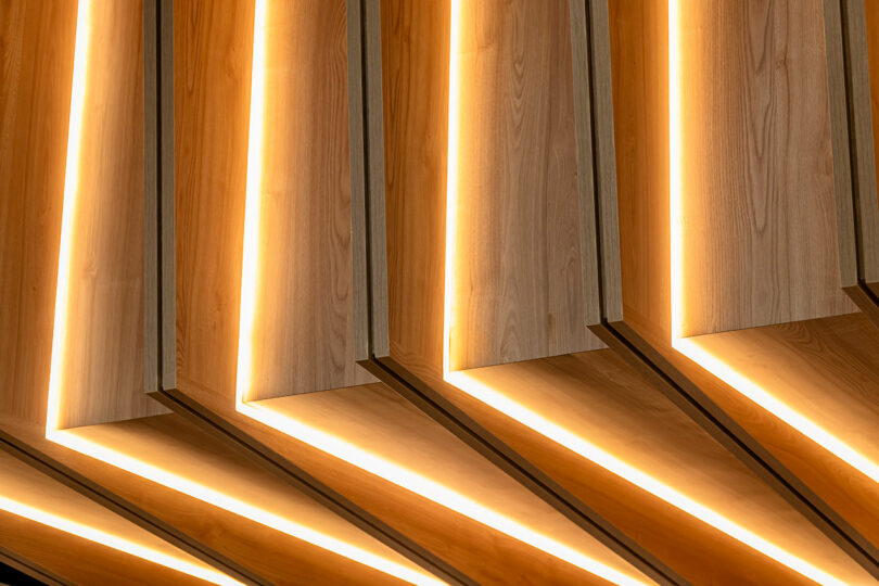 Modern wooden slats illuminated from within, creating a warm, ambient glow.