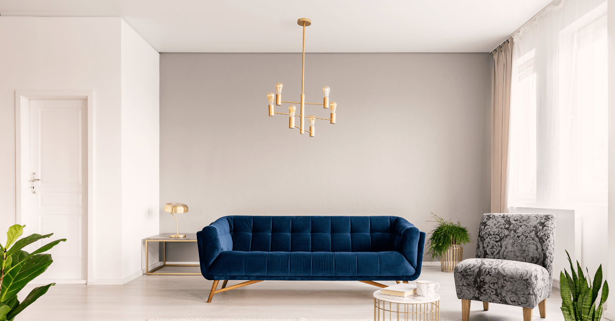 A blue couch with white painted ceiling.