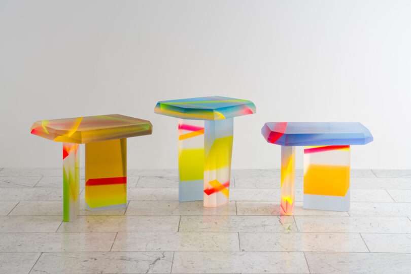 three colorful lucite coffee tables