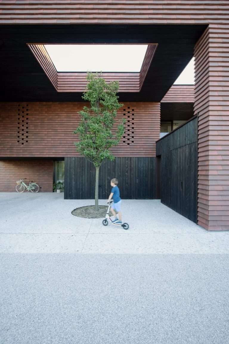 OFIS Arhitekti clads geometric home in Slovenia with red-brick tiles