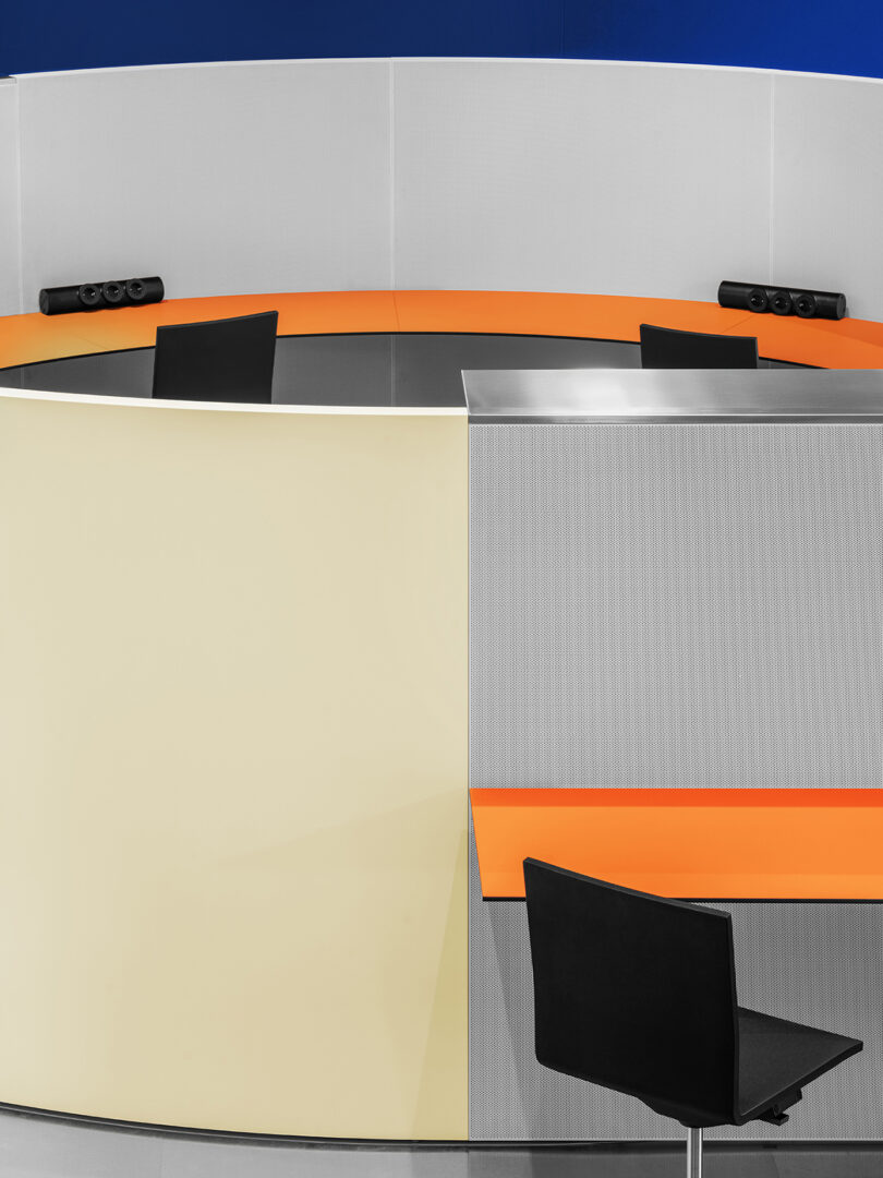 A desk with modern design punctuated with orange.