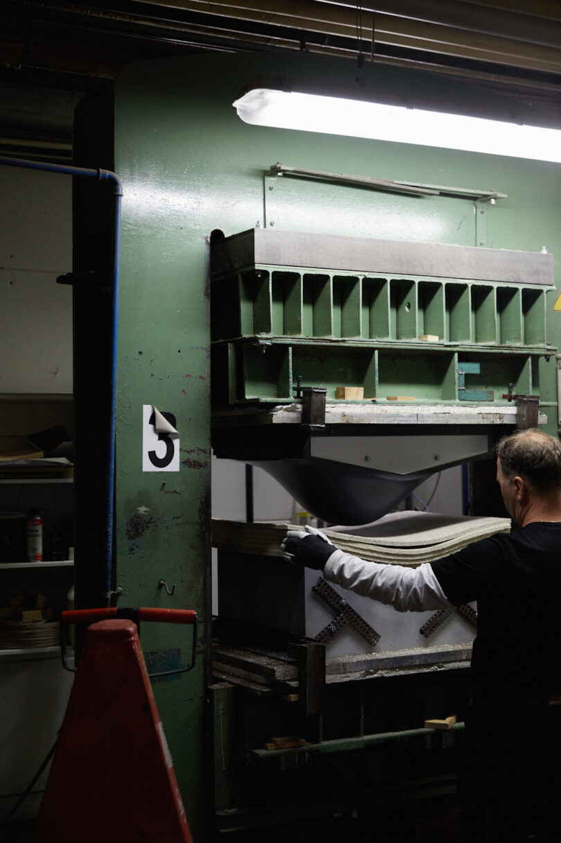 man pressing mold of shel chairs