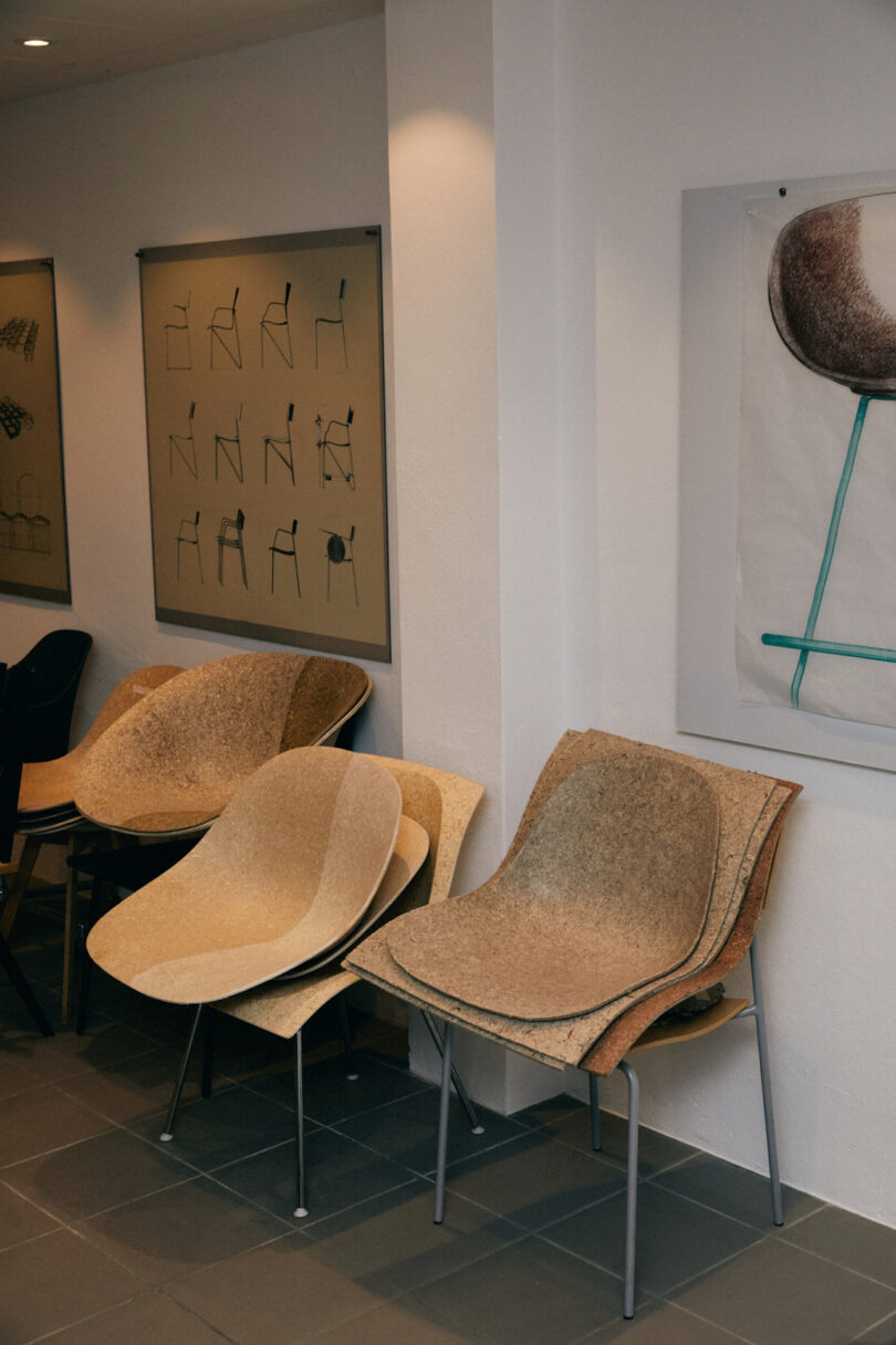 shell chairs lined up against a wall