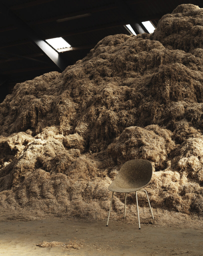 chair in front of a large pile of hemp fibers