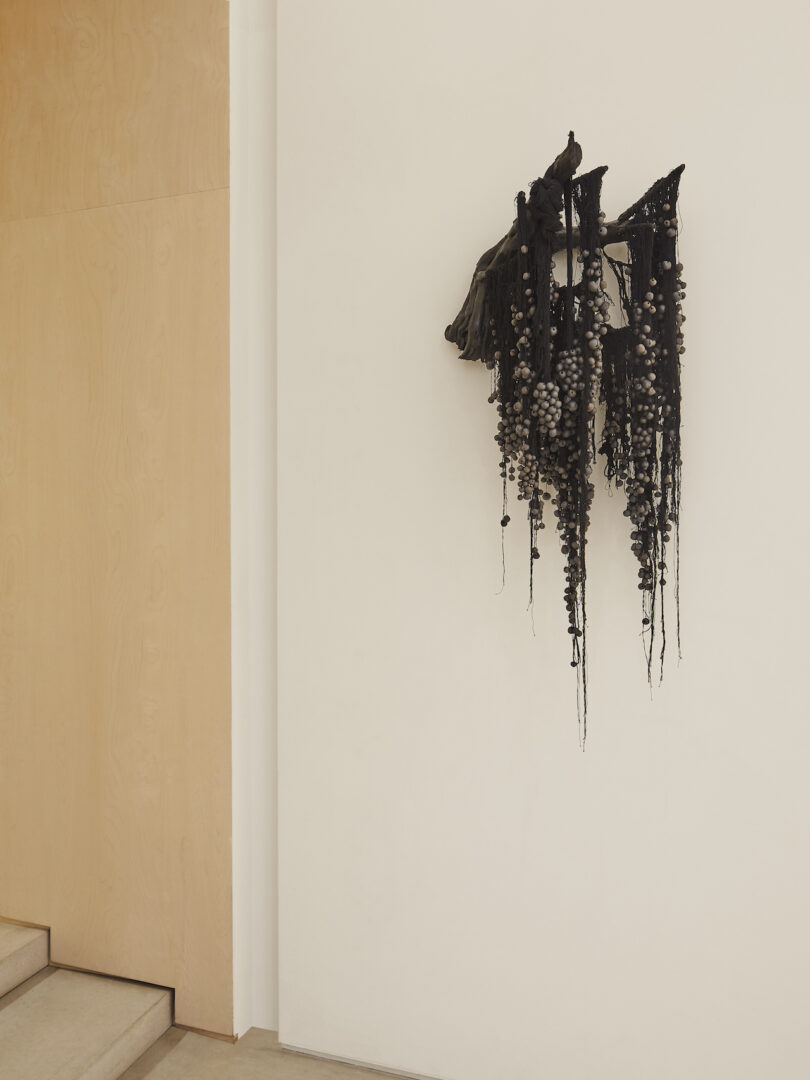 black sculptural wall hanging on a wall
