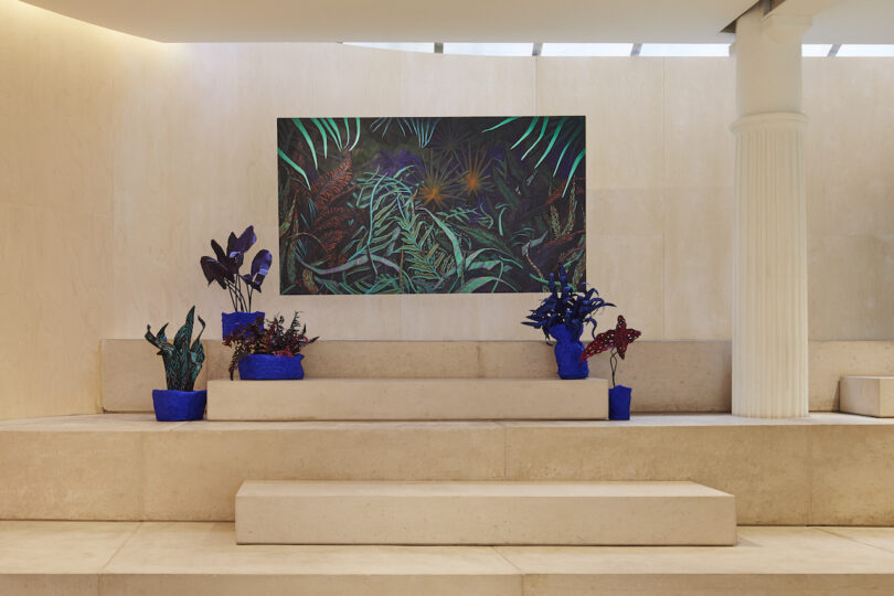 vibrant tropical-themed painting displayed above steps adorned with flower sculptures.