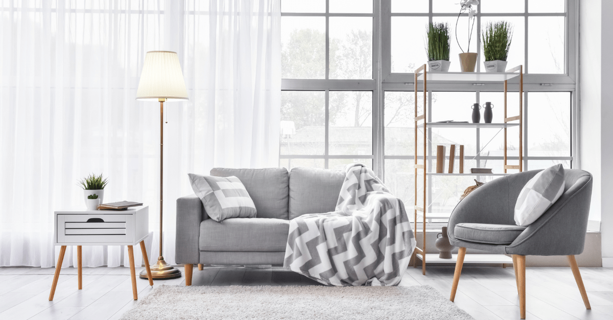 Modern living room with grey couch and chair.