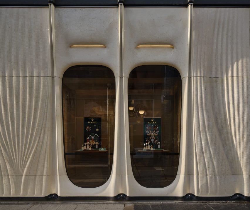 Pair of windows within curvaceous limestone facade