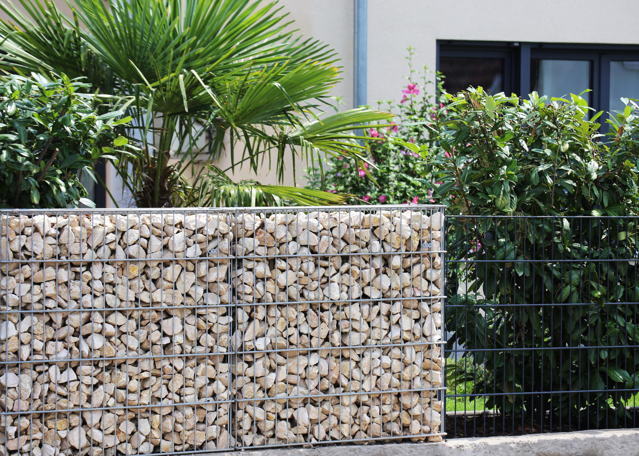 gabion wall blocking garden filled with rocks