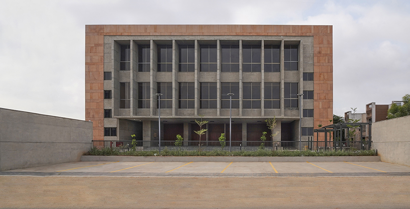 exposed concrete and pink sandstone shapes ini design studio's dahegam town hall in india