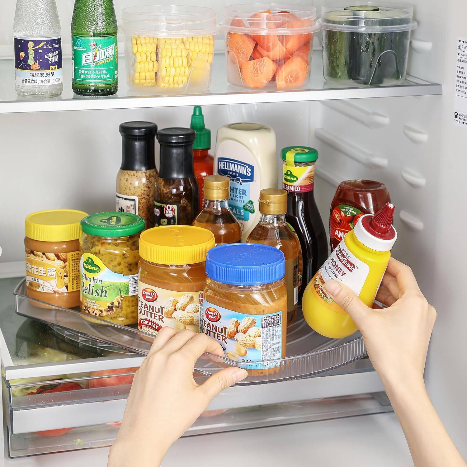 lazy susan in refrigerator with condiments on it.