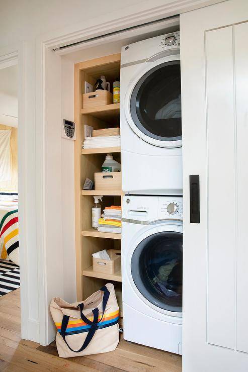 stacked laundry pair white hallway closet shelving beside bag on floor