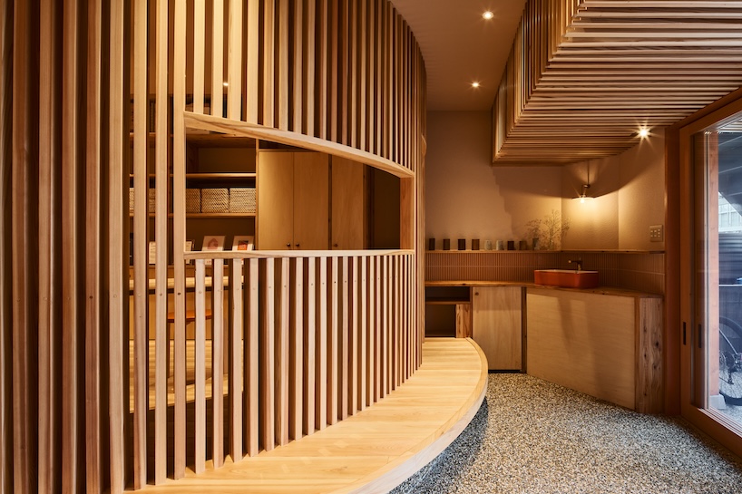 wooden louvers run along kyoto office space's entire interior by ujizono architects