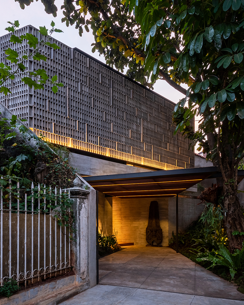 concrete breezeblocks clad residence's facade by wiyoga nurdiansyah architects