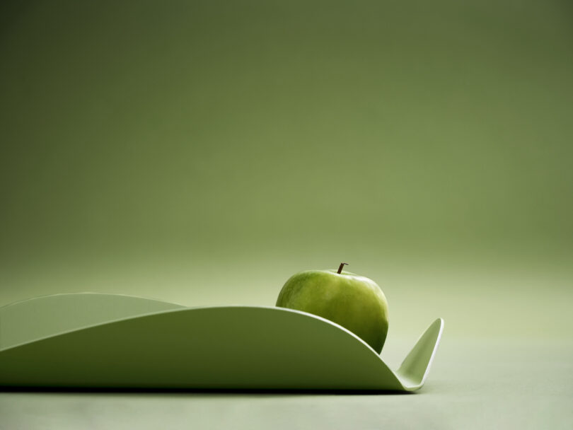 green alumimum tray with a green apple inside