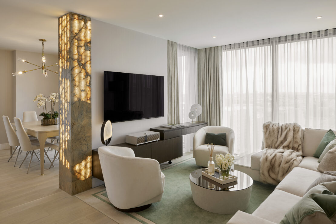 Luxury apartment in Battersea London designed in quite louxury style, with soft mint green tones, enhanced with white and gold. Living flowing into the dining room with a bespoke light up wall