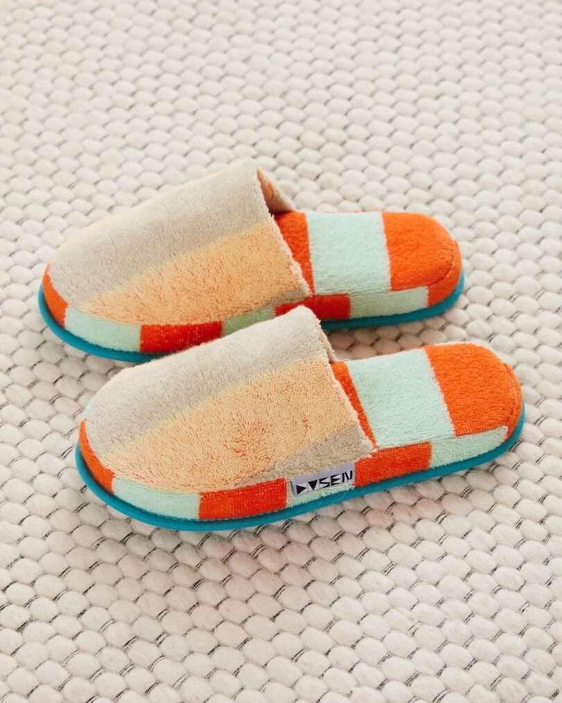 Dusen Dusen house slippers in an orange, light blue/teal blue striped design