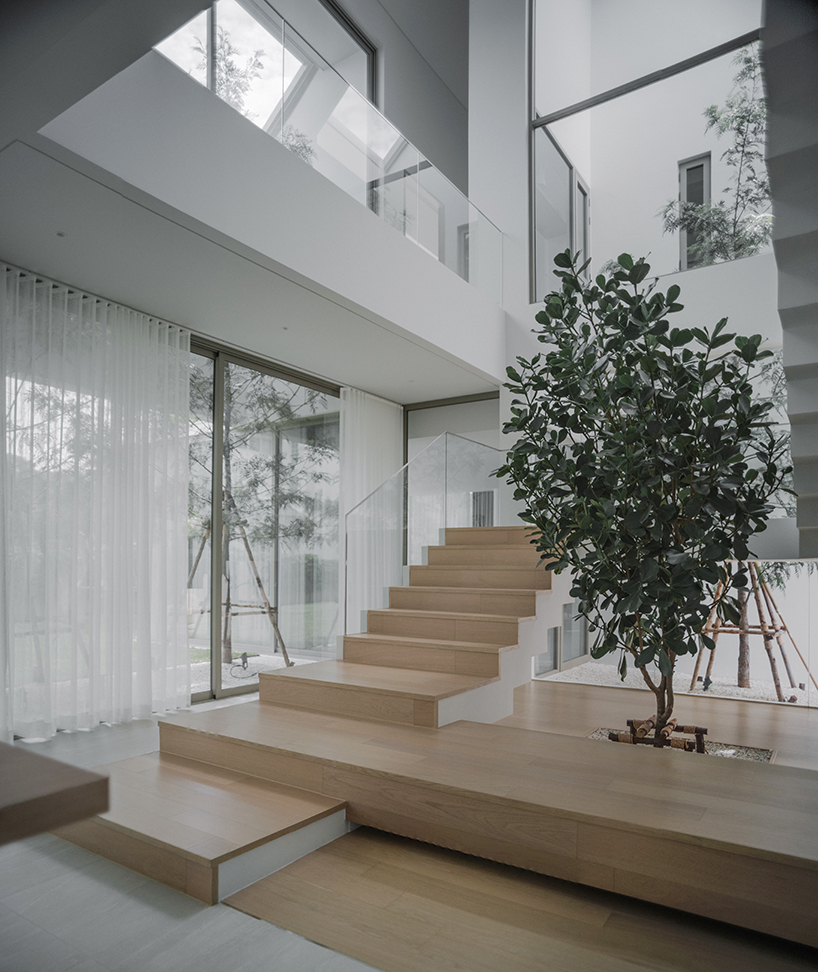 anonym studio's all-white house in bangkok adopts scandinavian minimalism