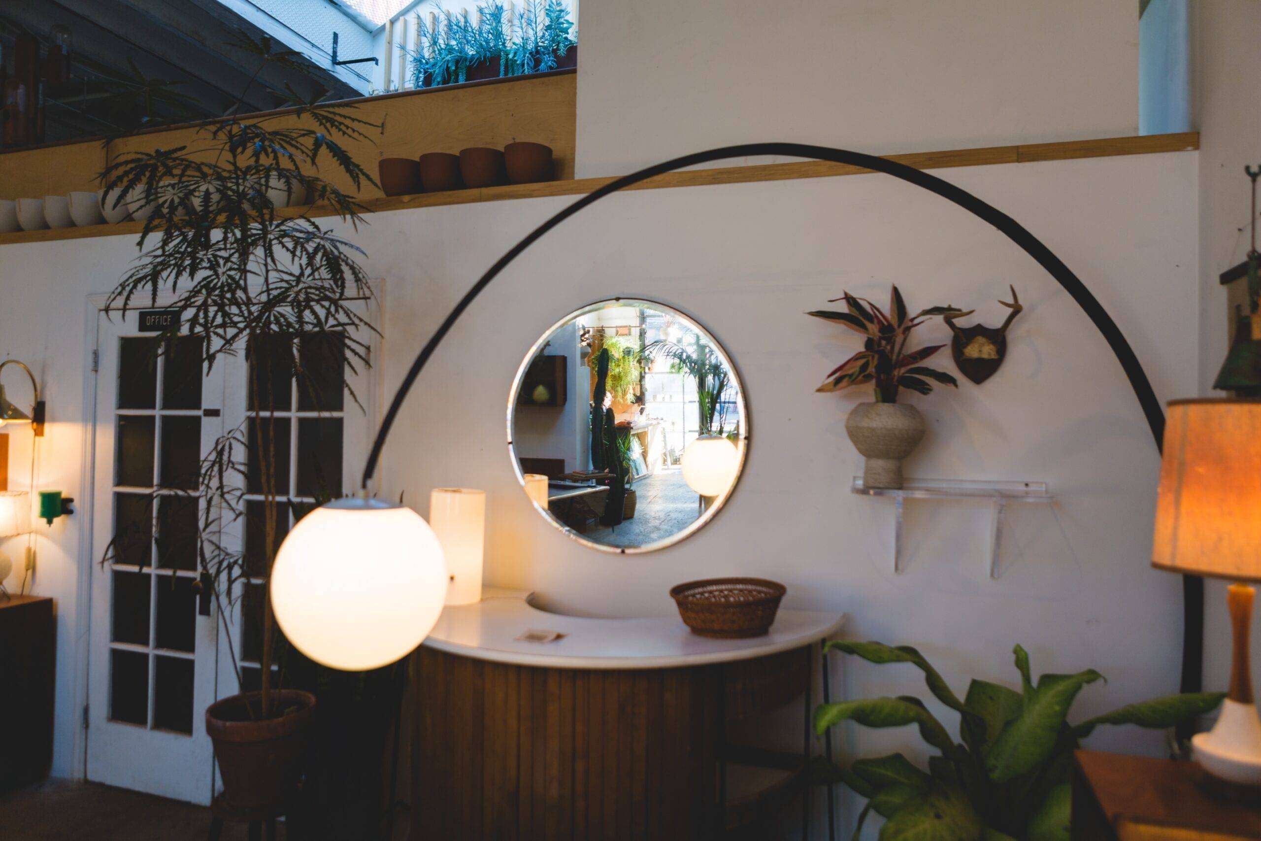 A large, curved MCM floor lamp with a spherical shade in a living room.