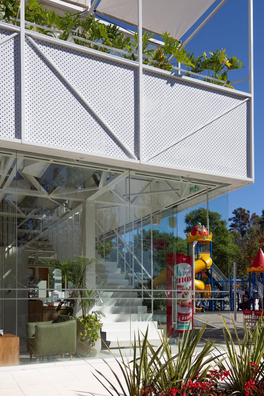 White metal ice cream parlour with playground in background