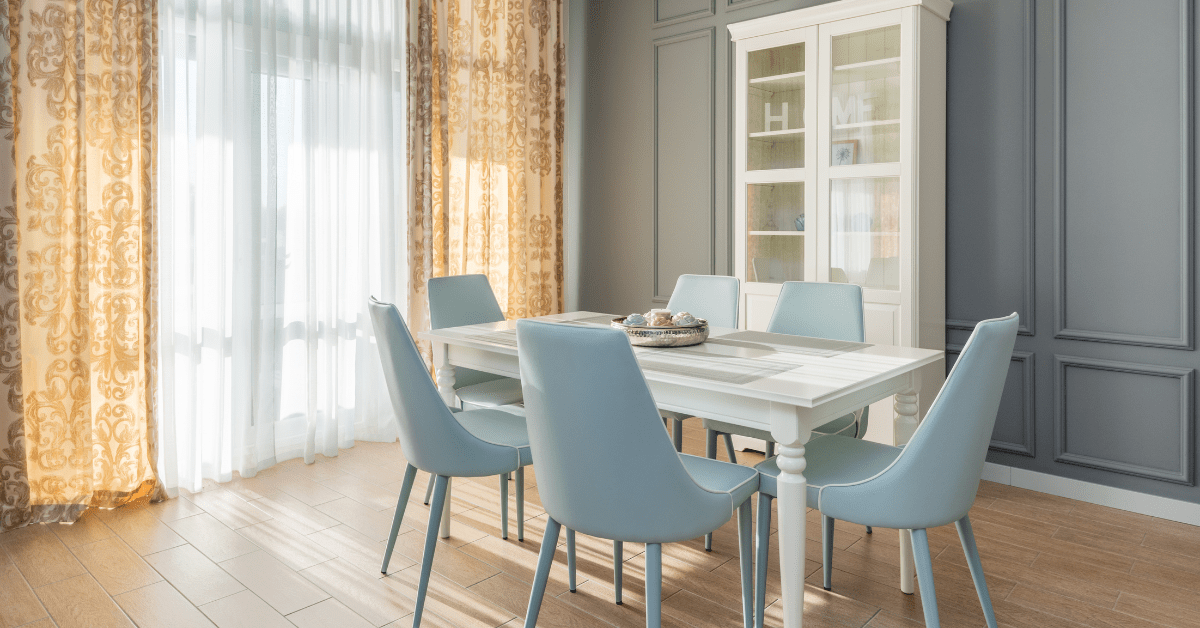 Blue chairs and a white dining room table.